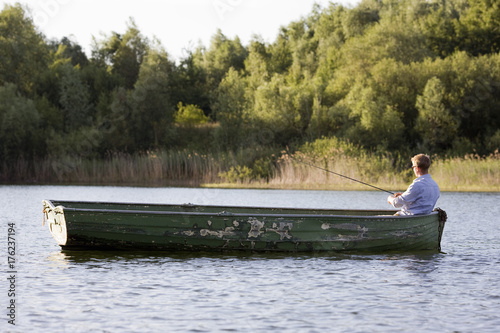 Fototapeta man fishing in rowboat
