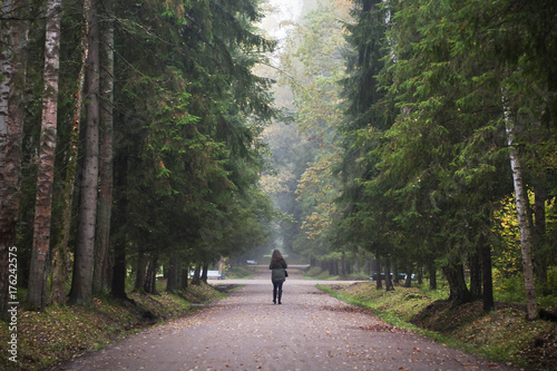 Girl walk in forest alone. 