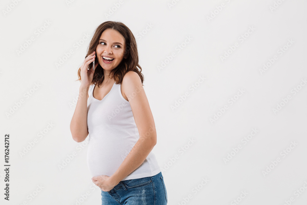 Smiling pregnant woman talking by mobile phone Smiling pregnant woman talking by mobile phone