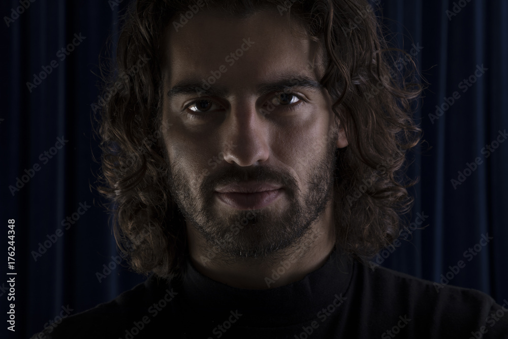 Portrait of young man with long hair.