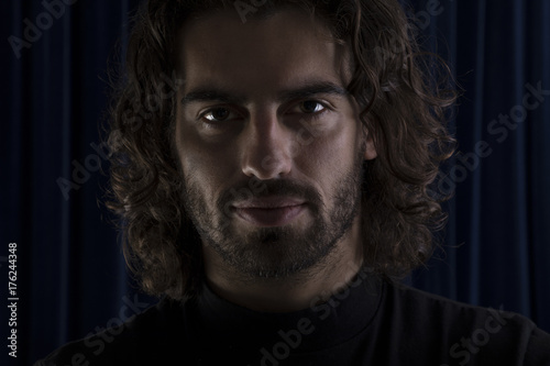 Portrait of young man with long hair.