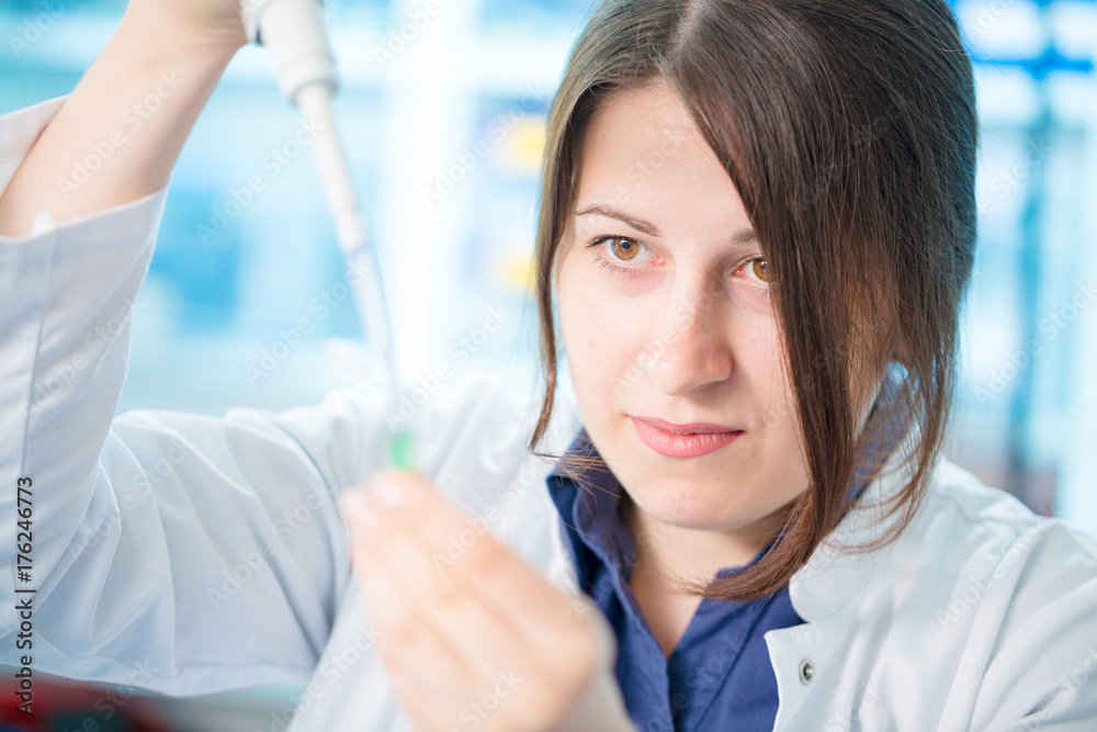 young woman lab assistant in a genetics lab young woman lab assistant in a genetics lab