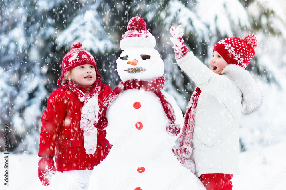 Kids building snowman. Children in snow. Winter fun. Kids building snowman. Children in snow. Winter fun.