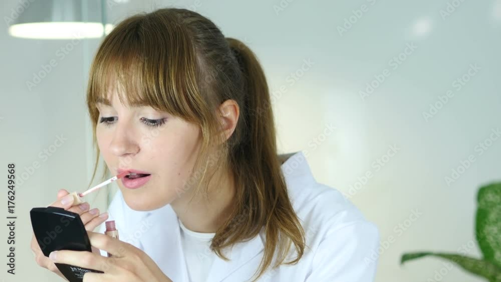 Portrait of Beautiful Girl Putting Lipstock on Lips Portrait of Beautiful Girl Putting Lipstock on Lips