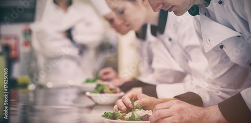Culinary class in kitchen making salads