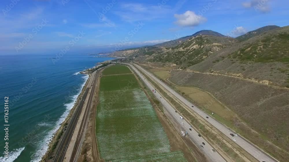 Epic aerial shot of plantation field near the Pacific ocean and freeway Epic aerial shot of plantation field near the Pacific ocean and freeway