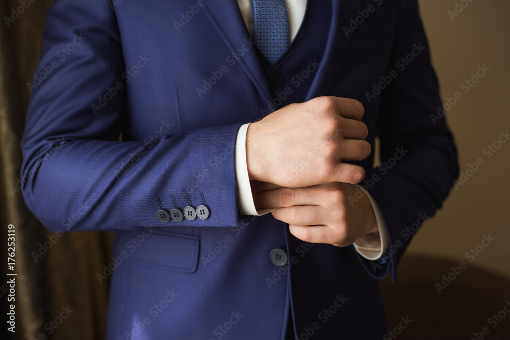Closeup photo of handsome stylish adult man getting ready for formal event. Horizontal color photography.