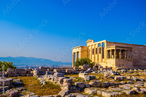 Erechtheion temple in Athens during the sunset. Ruins of the Temple of Erechtheion and Temple of Athene at the Acropolis hill in Greece.
