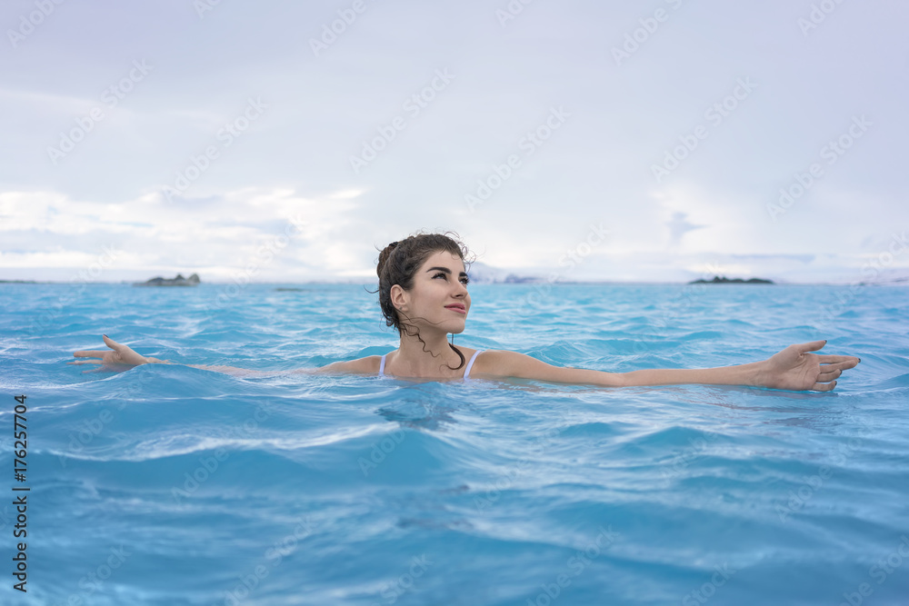 Girl relaxing in geothermal pool outdoors