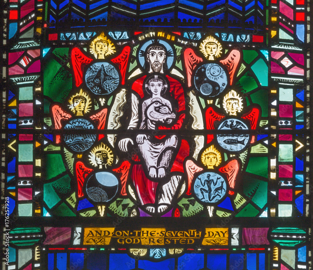 LONDON, GREAT BRITAIN - SEPTEMBER 16, 2017: The stained glass of Creation and symbolic Trinity in church St Etheldreda by Charles Blakeman (1953 - 1953).