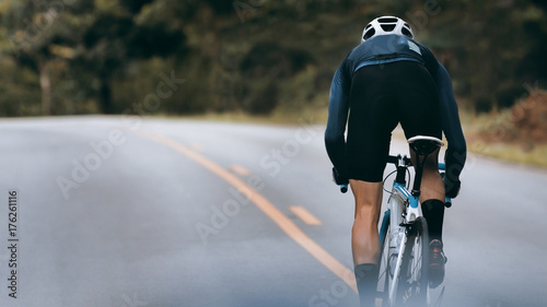 Cyclist increase speed by sprint. photo