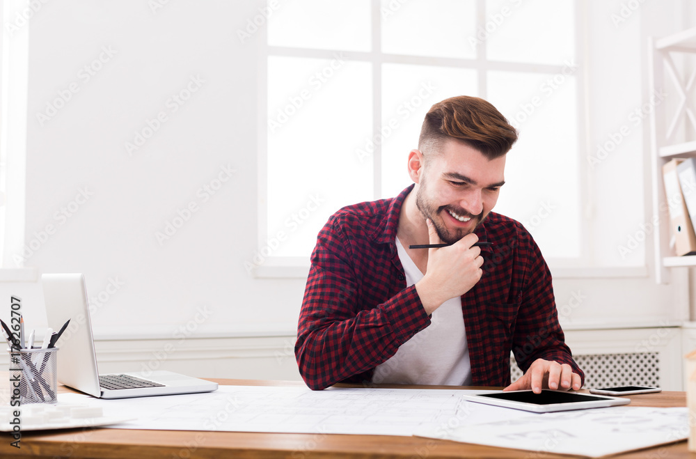 Architect working on blueprint in office Architect working on blueprint in office