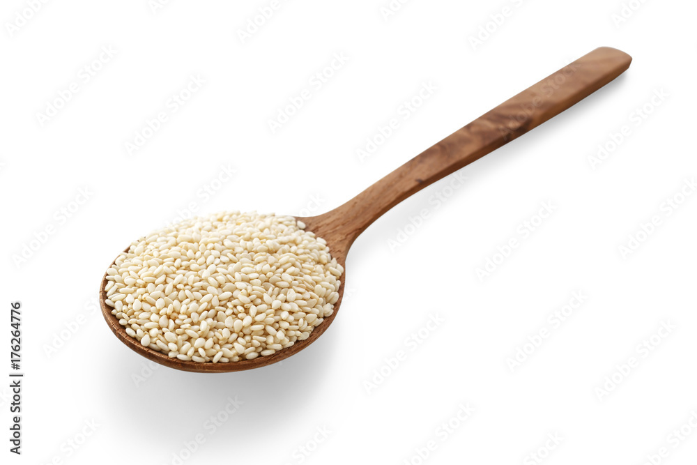 White sesame on wood spoon on white background White sesame on wood spoon on white background