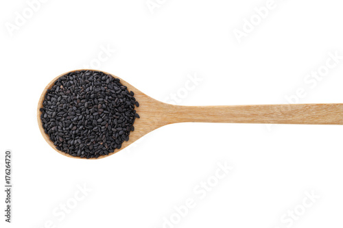 Black sesame on wood spoon isolated on white background