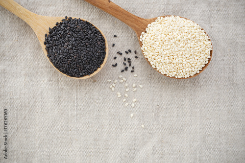Black and white sesame on wood spoon background with space