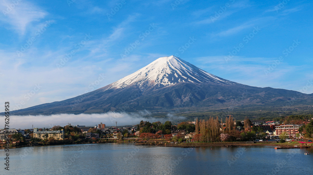 Mountain Fuji and Kawaguchiko lake with morning mist and blue sky background in Autumn season in  Japan.