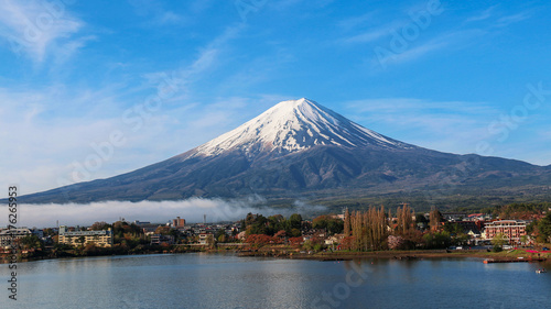 Mountain Fuji and Kawaguchiko lake with morning mist and blue sky background in Autumn season in Japan.