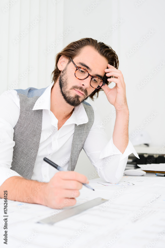 Fototapeta premium handsome young trendy business man working in architect office creative activity