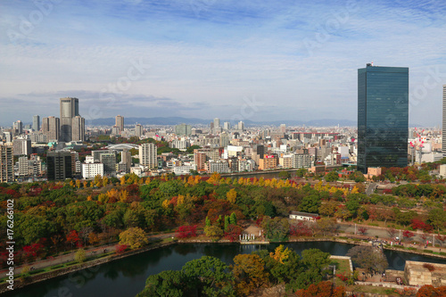  Osaka city with autumn maple leaves in a fine clear blue sky day.