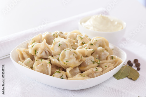Russian cuisine hot meat dumplings served with herbs