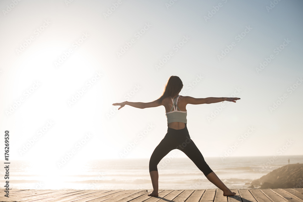 Fototapeta premium Women doing pilates on the beach