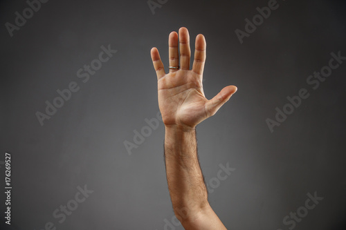 hand on a gray background. open palm © Yuriy Pankratov