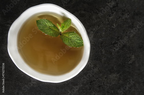 Fresh mint leaves in tea. Italian herbs. Dark background.