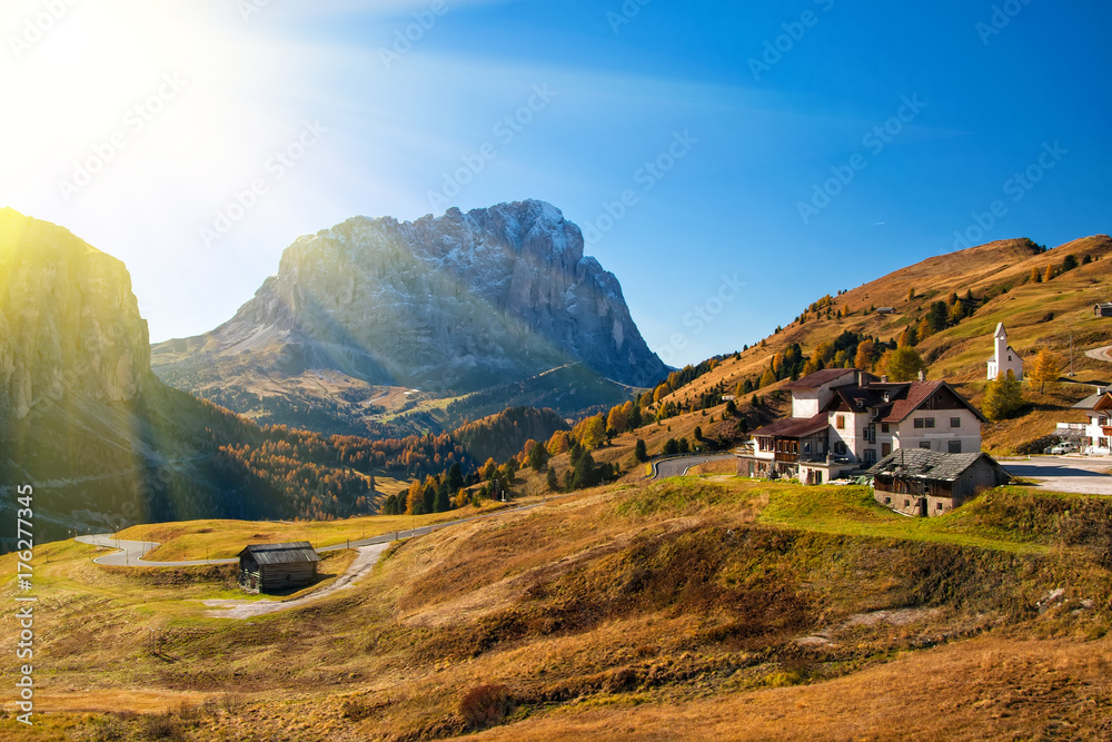 Amazing autumn view on Sassolungo mountain and Gardena Pass. Dolomite Alps, South Tyrol, Italy.