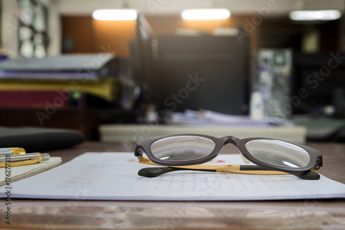 A eye glasses on report documents in office