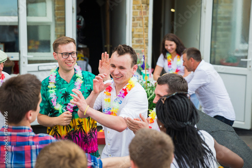 The young people dancing on the home party outdoors