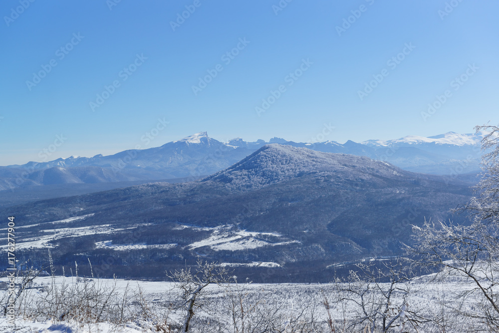 Snow-capped mountain peaks of the Caucasus mountains. The view from the plateau of Lago-Naki plateau to the river valley White