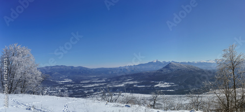 Snowy mountain peaks of the Caucasus mountains in January. The view from the plateau Lago-Naki in the valley of the White river