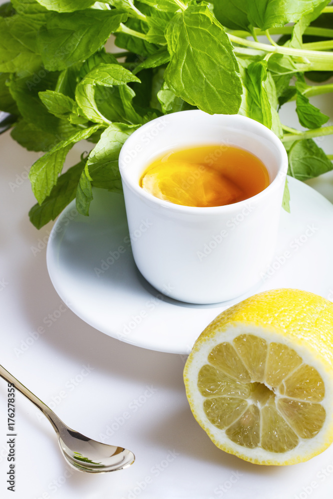 Tea with lemon and mint in the background Tea with lemon and mint in the background