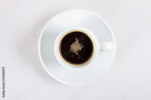 A cup of hot coffee on white, top view