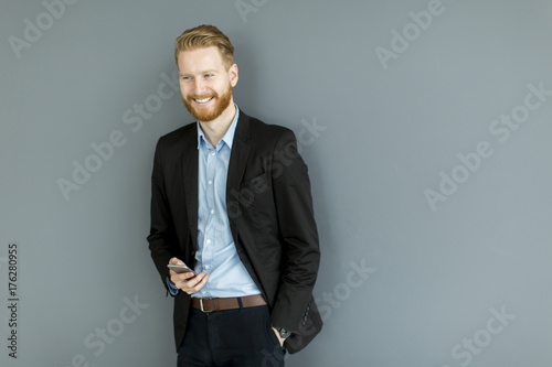 Redhair man using mobile ph...