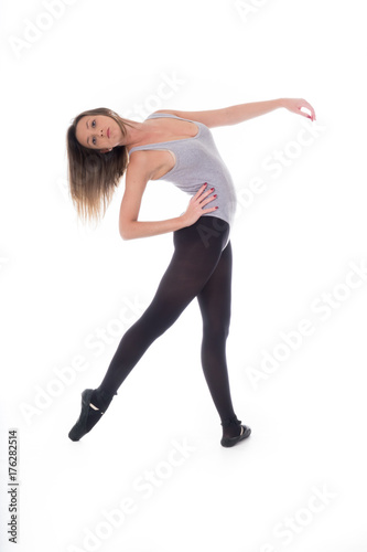 young beautiful woman dancer with long black hair wearing gray vest and tights jumping on a light white studio background