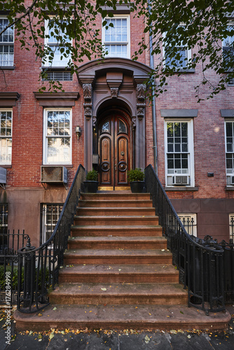 an ornate door on a brownstone building
