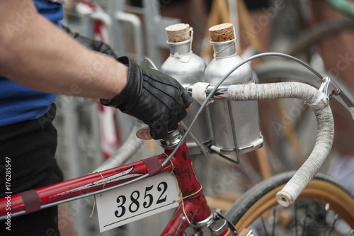 Vintage bicycle with aluminum canteen on the handlebar photo