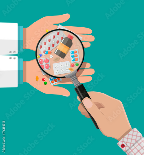 Hand of the pharmacist with pills and drugs