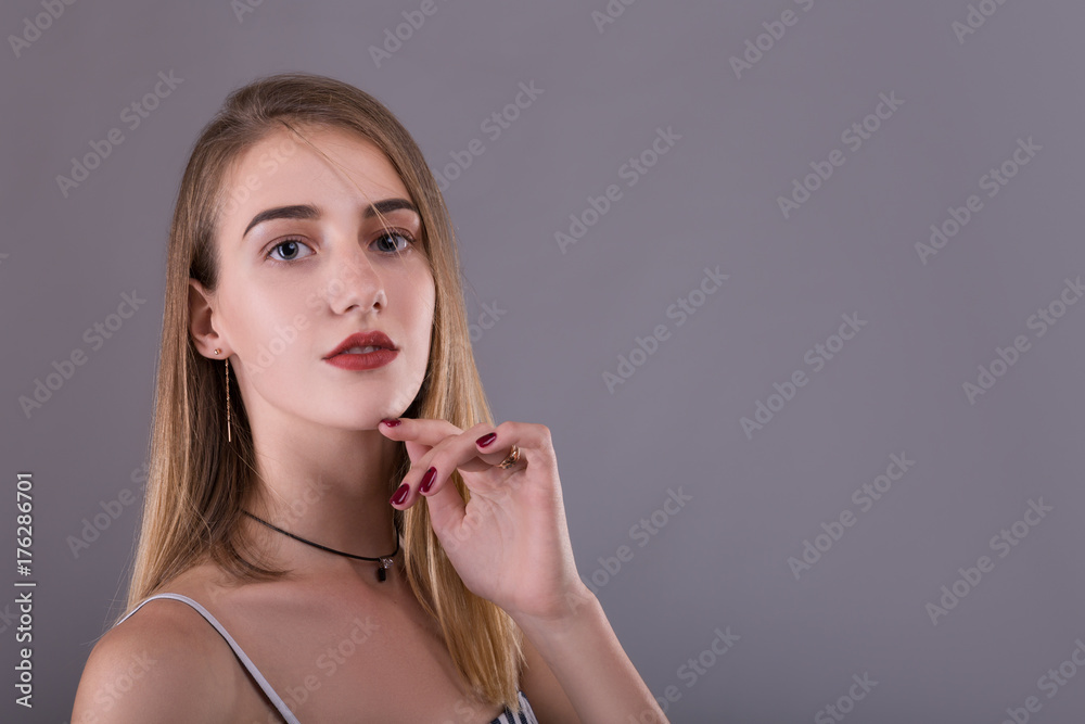 Beauty Woman face Portrait. Beautiful model Girl with Perfect Fresh Clean Skin. Blonde hair Youth and Skin Care Concept. on a gray background Beauty Woman face Portrait. Beautiful model Girl with Perfect Fresh Clean Skin. Blonde hair Youth and Skin Care Concept. on a gray background