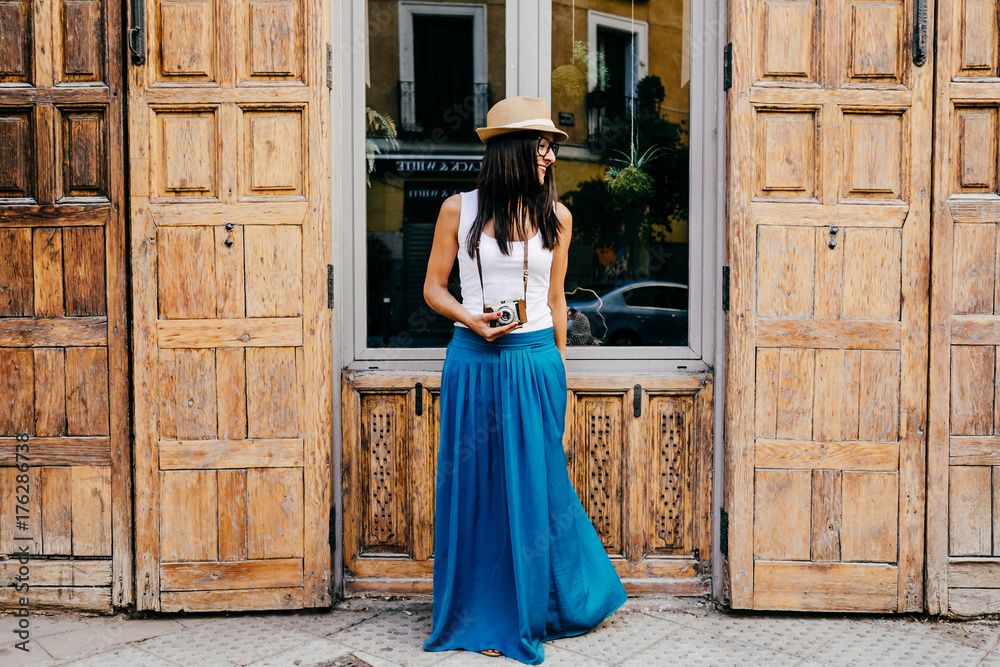 .Pretty young woman walking around downtown in a summer day taking photos. Woman in a good mood so happy. Lifestyle portrait. .Pretty young woman walking around downtown in a summer day taking photos. Woman in a good mood so happy. Lifestyle portrait.