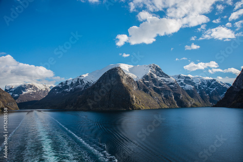 Fjord with snow capped mountians as background 