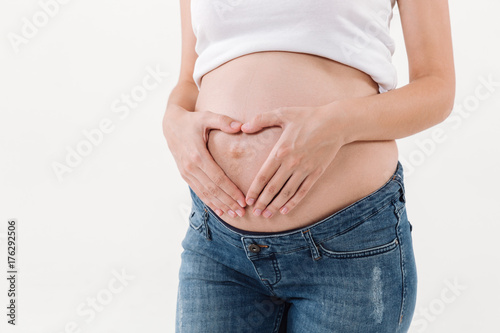 Cropped image of pregnant woman holding her hands on tummy © Drobot Dean