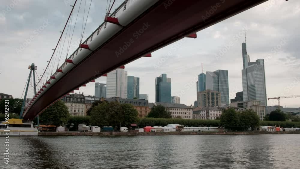 Dramatic wide angle clip of Holbeinsteg bridge framing the River Main and Frankfurt skyline Dramatic wide angle clip of Holbeinsteg bridge framing the River Main and Frankfurt skyline