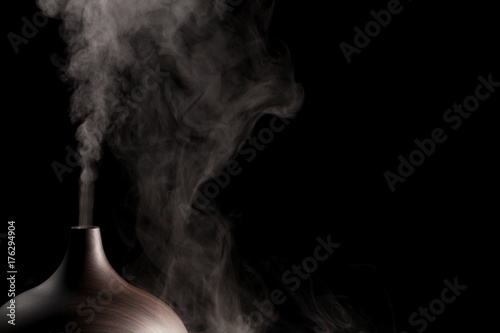 Alternative spa therapy device. Electric essential oil aromatherapy diffuser producing vapor.