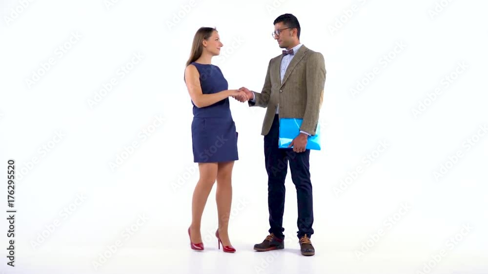Two business partners shake hands welcoming each other in studio. Slow motion Two business partners shake hands welcoming each other in studio. Slow motion