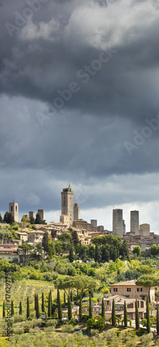 vertical panorama with towers under clouds in Italy