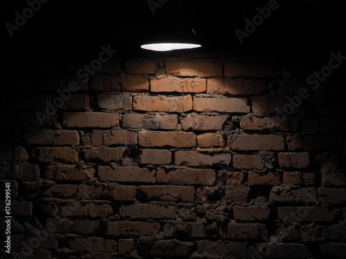 old wall lantern     .The old brick wall is lit by a flashlight