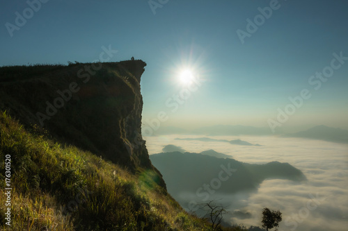 sunrise in the morning with light, flare In the misty atmosphere surrounded by mountains, place Phu Chi Fa, Thailand