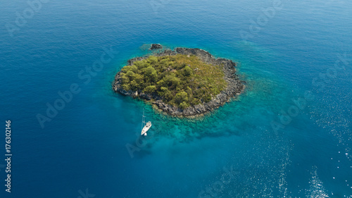 Sailing boat anchored to little island © doruk